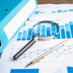 Business charts and reports with a magnifying glass