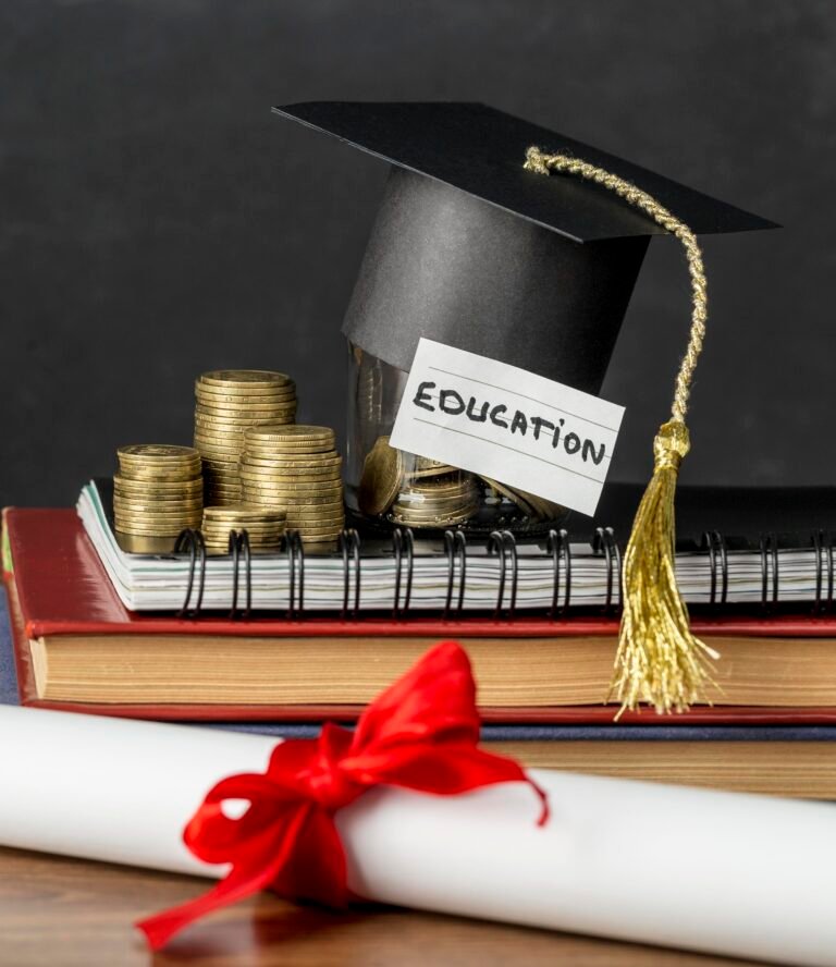 Graduation cap on an education savings jar, books and diploma