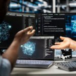 Data science team analysing neural network graphs on screens